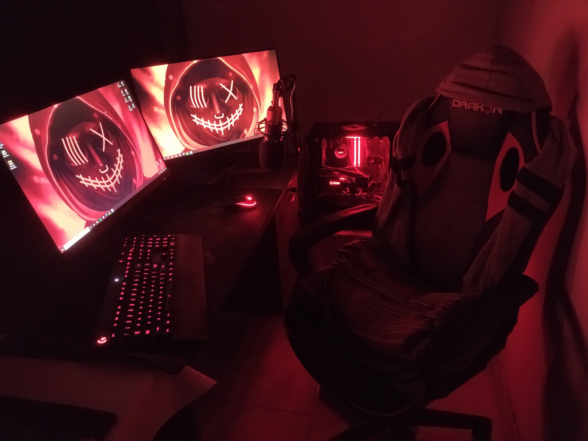 Red-lit gaming and creative PC setup by Sanuja Ashan